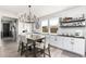 Charming dining room featuring stylish chandelier, shiplap accent wall, and open design at 10043 W Foothill Dr, Peoria, AZ 85383