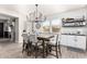 Bright dining area with a large table, stylish chandelier, and wainscoting at 10043 W Foothill Dr, Peoria, AZ 85383