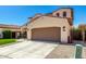 Charming two-story home featuring a three-car garage and a landscaped front yard at 10043 W Foothill Dr, Peoria, AZ 85383