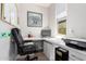 Bright home office featuring a modern desk, comfortable chair, and a window for natural light at 10043 W Foothill Dr, Peoria, AZ 85383