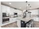 Modern kitchen boasts stainless steel appliances, granite island, and ample storage space at 10043 W Foothill Dr, Peoria, AZ 85383