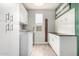 Clean laundry room with white cabinets, modern washer and dryer, and a convenient folding area at 10043 W Foothill Dr, Peoria, AZ 85383