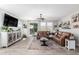 Spacious living room with leather sofa, modern lighting, and sliding door to the backyard at 10043 W Foothill Dr, Peoria, AZ 85383