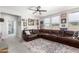 Spacious living room featuring a large leather sectional, decorative rug, and ample natural light at 10043 W Foothill Dr, Peoria, AZ 85383
