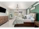 Bright main bedroom features modern decor, an elegant chandelier and an accent wall at 10043 W Foothill Dr, Peoria, AZ 85383