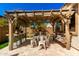 Backyard patio with pergola, string lights, and dining table, perfect for outdoor entertaining at 10043 W Foothill Dr, Peoria, AZ 85383