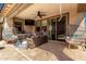 Comfortable outdoor patio featuring stylish wicker furniture, ceiling fan, and tile flooring at 10043 W Foothill Dr, Peoria, AZ 85383