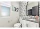 Stylish powder room featuring decorative wallpaper, vanity with a gray countertop, and modern fixtures at 10043 W Foothill Dr, Peoria, AZ 85383