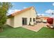 The backyard features a patio area, artificial grass, and lush landscaping, creating a private outdoor oasis at 11033 E Poinsettia Dr, Scottsdale, AZ 85259