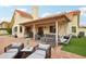 Relaxing backyard patio featuring ample seating, a built-in grill, and a charming porch swing for outdoor enjoyment at 11033 E Poinsettia Dr, Scottsdale, AZ 85259