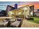 Backyard patio features a covered seating area, lush artificial grass, and ambient lighting for relaxing outdoor living at 11033 E Poinsettia Dr, Scottsdale, AZ 85259