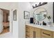 Bright bathroom with wood vanity, white countertop, and trendy round mirror at 11033 E Poinsettia Dr, Scottsdale, AZ 85259