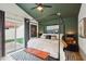 Bright primary bedroom with large bed, green vaulted ceilings and sliding glass doors at 11033 E Poinsettia Dr, Scottsdale, AZ 85259