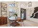 Charming dining area with a round table, decorative lighting, and a view of the front entrance at 11033 E Poinsettia Dr, Scottsdale, AZ 85259