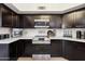 Close-up of kitchen appliances, countertops, and dark cabinetry at 11033 E Poinsettia Dr, Scottsdale, AZ 85259