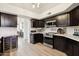 Stylish kitchen with dark cabinets, stainless steel appliances, and ample counter space at 11033 E Poinsettia Dr, Scottsdale, AZ 85259