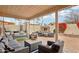 Inviting outdoor patio with cozy seating, fireplace, lush landscaping and string lights at 11033 E Poinsettia Dr, Scottsdale, AZ 85259