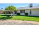 Landscaped backyard with an enclosed patio area and vibrant green grass at 12634 W Seneca Dr, Sun City West, AZ 85375