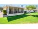 Well-maintained backyard showcasing enclosed patio and manicured lawn at 12634 W Seneca Dr, Sun City West, AZ 85375