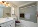 Clean bathroom featuring a shower and bathtub, vanity, and neutral decor at 12634 W Seneca Dr, Sun City West, AZ 85375