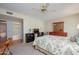 Comfortable bedroom with wood floors, natural light, and a view into the bathroom at 12634 W Seneca Dr, Sun City West, AZ 85375