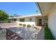 Charming courtyard featuring tiled flooring, a decorative sun, and a landscaped garden area at 12634 W Seneca Dr, Sun City West, AZ 85375