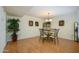Elegant dining room with a glass table, seating for four, and a decorative chandelier at 12634 W Seneca Dr, Sun City West, AZ 85375