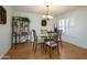 Elegant dining room featuring a glass-top table, seating for four, and stylish decor at 12634 W Seneca Dr, Sun City West, AZ 85375