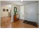 Inviting entryway featuring wood flooring, a stylish dresser, and a view into the dining room at 12634 W Seneca Dr, Sun City West, AZ 85375
