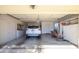 Spacious garage with a car parked inside, and built-in storage cabinets at 12634 W Seneca Dr, Sun City West, AZ 85375