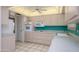 Well-lit kitchen featuring built-in oven, microwave, light wood cabinets and blue backsplash at 12634 W Seneca Dr, Sun City West, AZ 85375