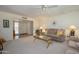 Bright living room featuring a plush sofa, ceiling fan, and ample natural light at 12634 W Seneca Dr, Sun City West, AZ 85375