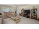 Bright living room with large windows, plush sofas, and a ceiling fan at 12634 W Seneca Dr, Sun City West, AZ 85375