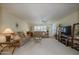 Spacious living room with plush sofas, ceiling fan, and ample natural light at 12634 W Seneca Dr, Sun City West, AZ 85375