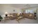 Spacious living room with plush sofas, ceiling fan, and ample natural light at 12634 W Seneca Dr, Sun City West, AZ 85375