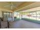 Cozy screened-in patio featuring ceiling fan and outdoor seating area at 12634 W Seneca Dr, Sun City West, AZ 85375