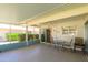 Comfortable screened-in patio area with ceiling fan and sliding glass doors at 12634 W Seneca Dr, Sun City West, AZ 85375