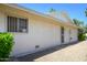 The side of a single-story home featuring a secure metal door and a well-maintained gravel area at 12634 W Seneca Dr, Sun City West, AZ 85375