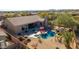 An aerial view of the backyard with a pool, spa, desert landscaping and mountain views at 13144 E Lupine Ave, Scottsdale, AZ 85259