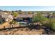 An aerial view of the home's backyard pool, spa, desert landscaping, and mountain views at 13144 E Lupine Ave, Scottsdale, AZ 85259