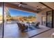 Inviting outdoor patio with comfortable seating, a built-in grill, mountain views, and access to the pool at 13144 E Lupine Ave, Scottsdale, AZ 85259