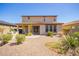 Exterior of home showcasing a large backyard with desert landscaping, a covered patio, and an outdoor kitchen at 13660 N 144Th Ln, Surprise, AZ 85379