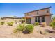 Wide view of a large backyard featuring desert landscaping, an outdoor kitchen, and a covered patio at 13660 N 144Th Ln, Surprise, AZ 85379