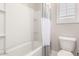 Bathroom features tub and shower with tiled walls and neutral shower curtain at 13660 N 144Th Ln, Surprise, AZ 85379