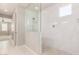 Luxurious bathroom features an all-glass shower with tiled walls and elegant fixtures at 13660 N 144Th Ln, Surprise, AZ 85379