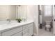 Bathroom featuring double sinks, quartz countertops, and a shower/tub combo at 13660 N 144Th Ln, Surprise, AZ 85379