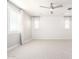 This bright bedroom boasts designer wallpaper, plush carpet, and modern window treatments at 13660 N 144Th Ln, Surprise, AZ 85379