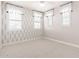 This bedroom boasts geometric wallpaper, plush carpet, and modern window treatments at 13660 N 144Th Ln, Surprise, AZ 85379