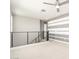 Second floor bonus room with neutral carpet, modern ceiling fan, and horizontal striped accent wall at 13660 N 144Th Ln, Surprise, AZ 85379