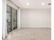 Neutral bonus room with wood-look tile flooring and a sliding glass door with decorative sunburst at 13660 N 144Th Ln, Surprise, AZ 85379